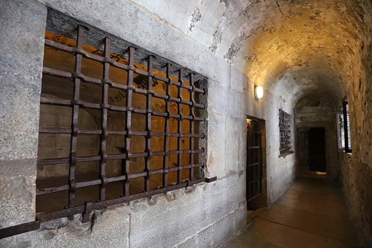 Barred window in a stone corridor of the palace prisons
